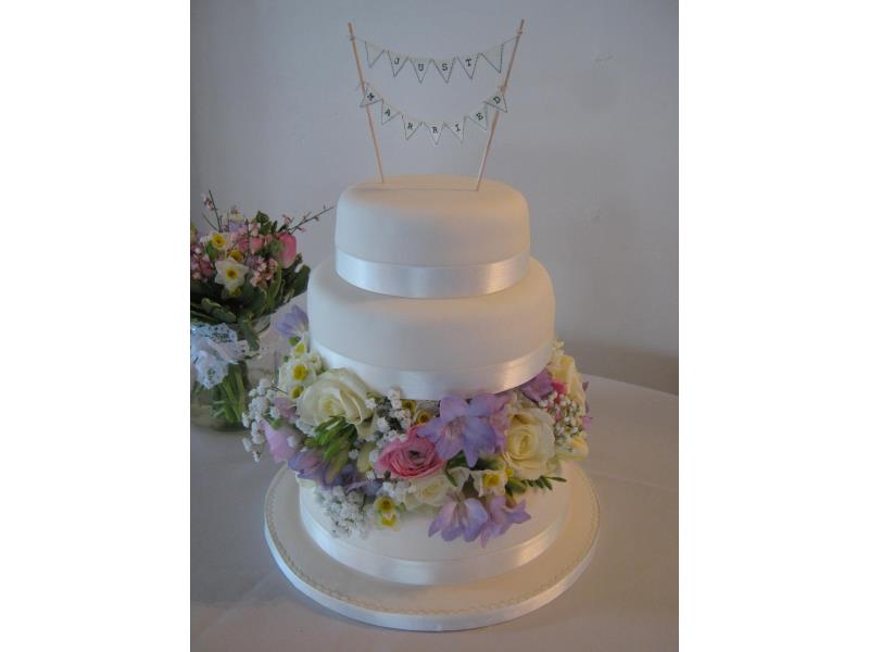 Shelley - three tier wedding cake with fresh flowers. Cakes are in sponge - Madeira, lemon and chocolate for wedding at #GreatHallof Mains