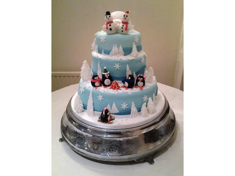 Christmast and winter themed wedding cake with penguins for Elisha and Chris's wedding at Barton Grange, Preston. Made from fruit cake, lemon sponge.