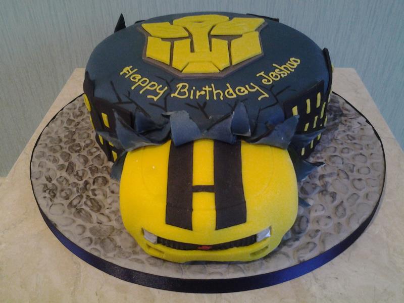 Transformer's logo with car breaking out birthday cake in chocolate sponge for Joshua in South Shore, Blackpool