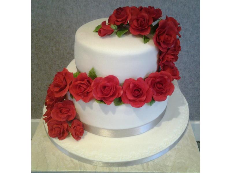 Cascading Roses design with hand modelled roses and chocolate and vanilla sponges. Made for Sam's wedding in Blackpool.