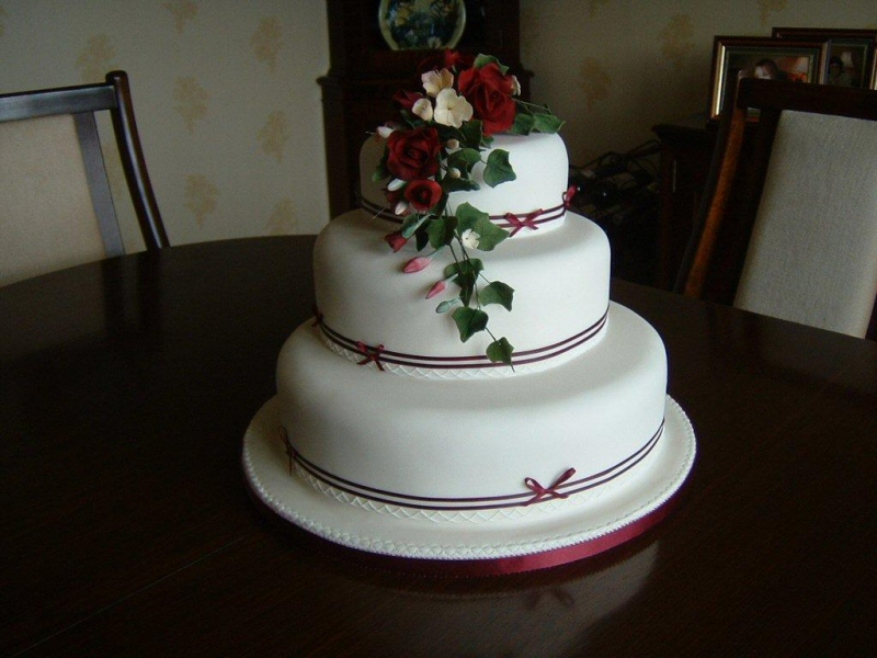 Ruby - 3 tier ivory sugarpaste wedding cake with freesias, roses and maroon banding